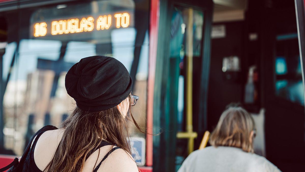 Photo of bus riders boarding a fixed route DART bus.
