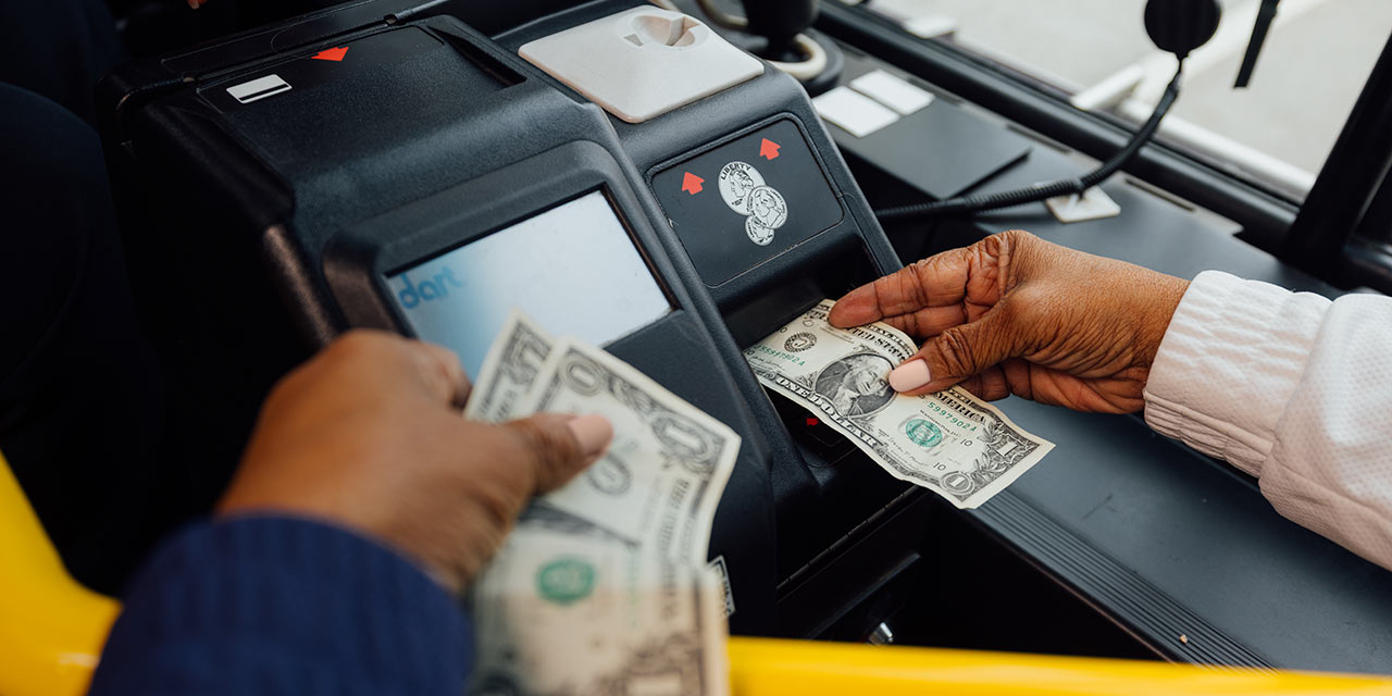 Woman paying bus fare with cash